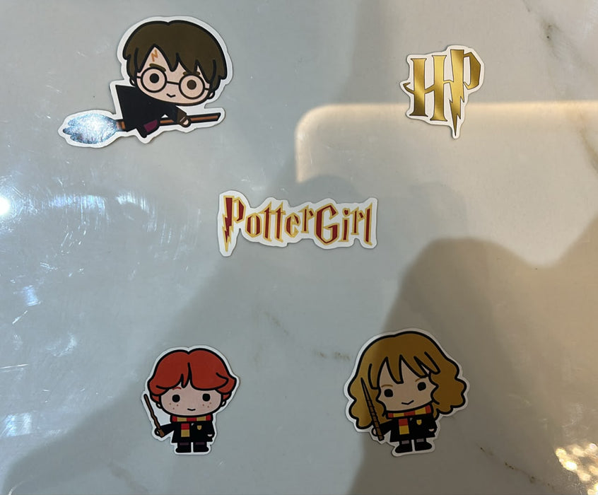 Set of Harry Potter-themed stickers on a marble surface